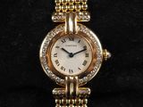 a close up of a gold watch with diamonds on it