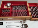 a wooden box with silverware in it on a table