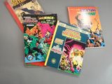several comic books sitting on top of a table next to each other