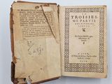 an old book with writing on it sitting on top of a table