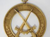 gold medal with two crossed swords and laurels on a white background