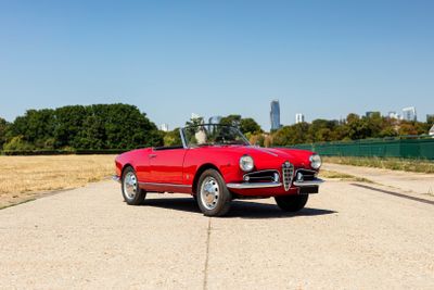 an image of a red convertible car parked on the side of the road