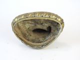 a small shell shaped object on a white surface