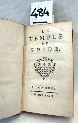 an open book with writing on it sitting on top of a table