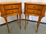pair of wooden nightstand tables with drawers on each side of them