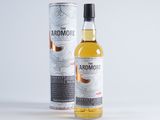 a bottle of arromore single malt whisky next to a canister