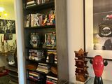 an image of a living room with bookshelves and pictures on the wall