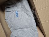 a box with a shirt inside of it on the floor