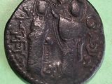 an old coin with a woman holding a child on it