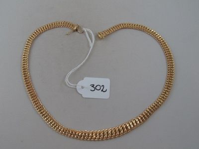 a close up of a gold necklace with a price tag on it