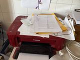 a printer sitting on top of a cluttered desk