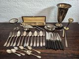 a lot of silver spoons and silverware on a table