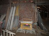 a pile of old metal and wood pieces in a room