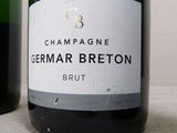 two bottles of champagne sitting next to each other on a table