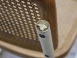 a close up view of a chair that has a stick sticking out of it