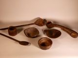 a lot of old wooden spoons and spoons on the table