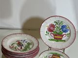 a stack of plates with flowers on them on a table