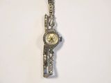 an image of a silver watch with a gold face on a white background