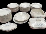 a lot of plates and bowls that are sitting on a table