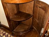 a corner cabinet with a marble top in the corner of a room