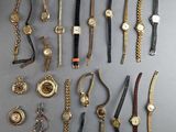 many different types of watches on display on a table