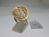 an image of a gold ring on a white surface with a price tag