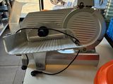 an image of a meat slicer sitting on a table in a store