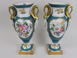 two vases that have been painted with flowers on them