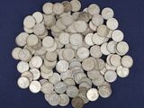 a pile of silver coins on a blue surface