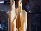 a tall vase that has several pieces of paper in it