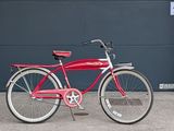 a red bicycle parked in front of a garage door