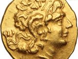 a close up of a gold coin with a man ' s head on it