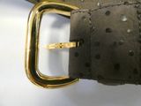 a close up of a belt with a gold buckle on it