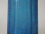 a blue glass vase that has a pattern on it