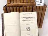 several old books are stacked on top of each other on a table