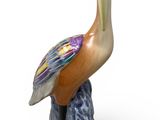 a figurine of a pelican sitting on a rock