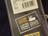 the label on the back of a black jacket with a barcode on it