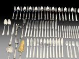 a lot of silver spoons and forks on the table