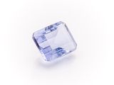 a square cut blue sapphire stone on a white background