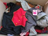 a cardboard box filled with clothes and other items