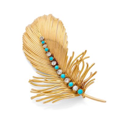 an image of a gold and turquoise feather broochle on a white background