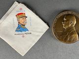 an image of a medal and a coin sitting next to each other