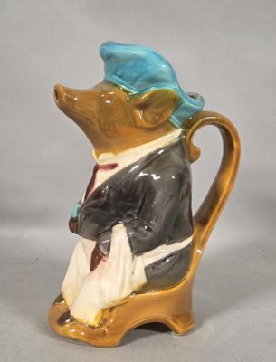 a figurine of a mouse in a suit and hat