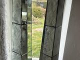 two mirrors sitting on a window sill next to each other