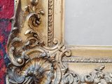 a picture of a gold frame on a red carpet