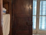 a wooden door in the corner of a room