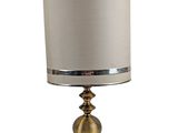 a close up of a lamp with a white shade on it