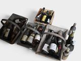 several bottles of wine are in a wooden case on a white surface