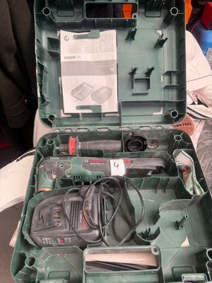 a green case with tools inside of it on a table