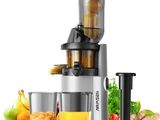 a close up of a juicer sitting next to a glass of juice